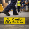 Caution Mind The Step Floor Graphic – 300mm x 100mm – Polycarbonate – Industrial Use